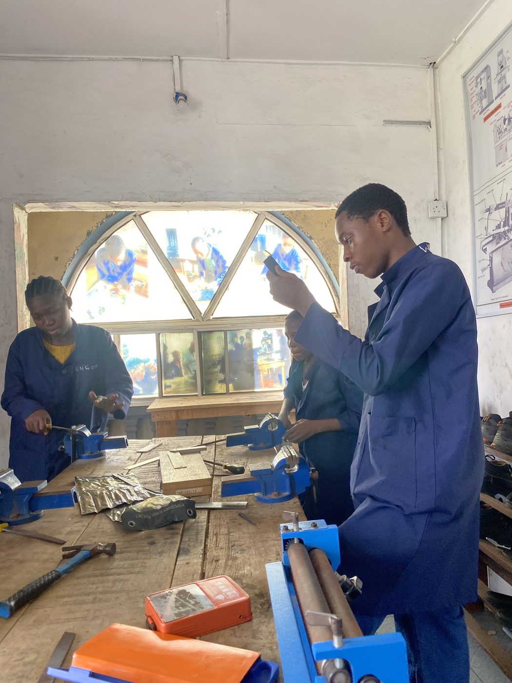 Trainees practising fitting skills at a workbench