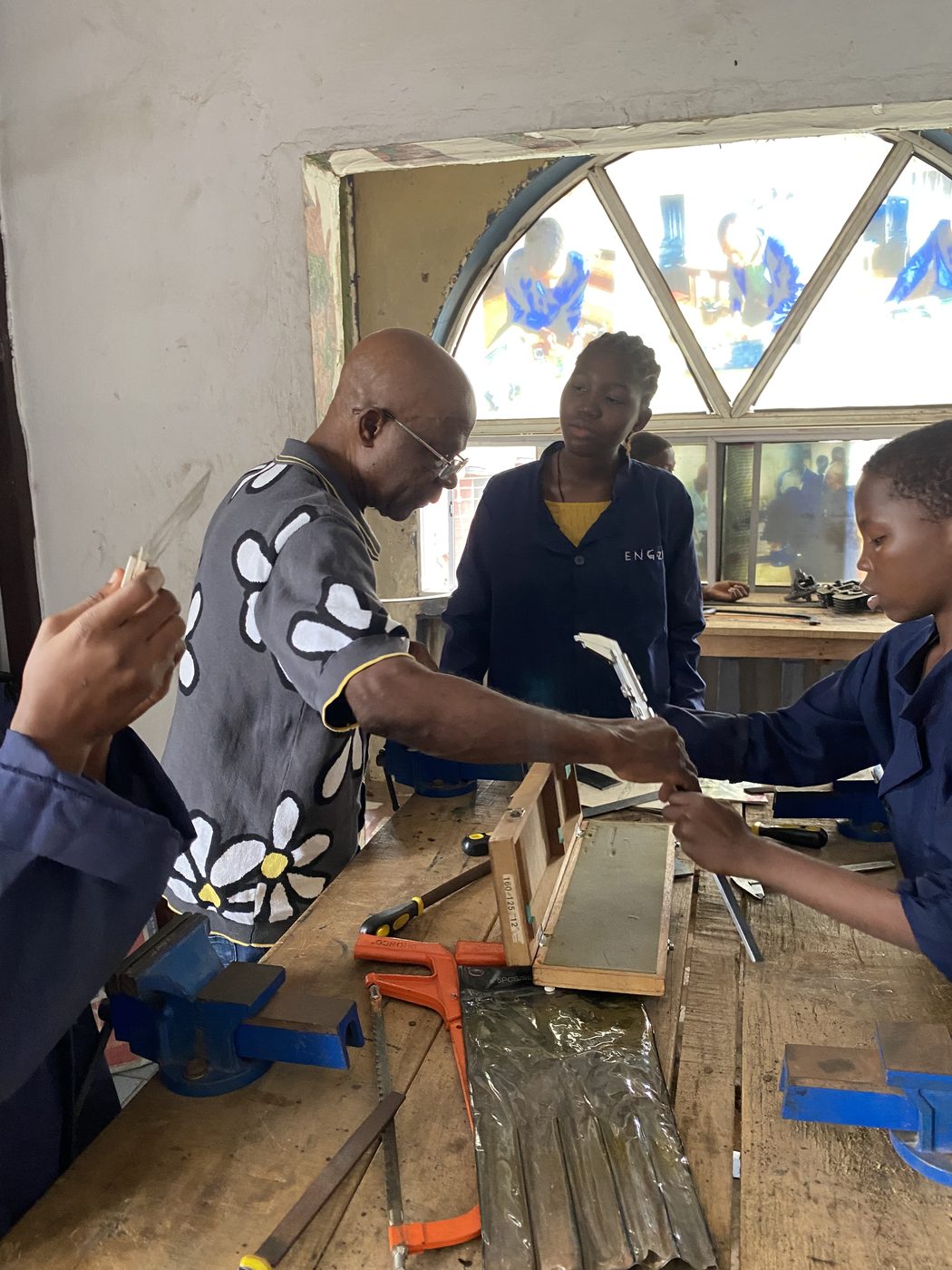 Instructor guiding trainees in quality control